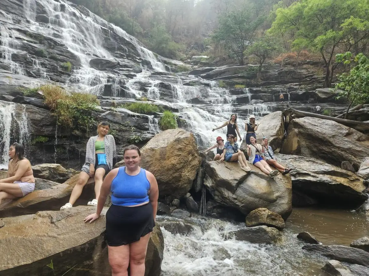 The group posing on the rocks at Mae Ya waterfall
