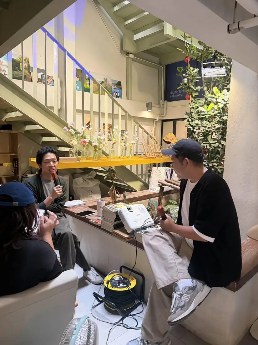 Kida speaking with a mic at an astrology talk in Chiang Mai